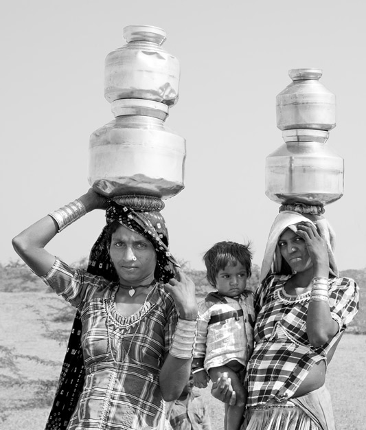 Human Right to Water in India - In the absence of water sources close to home, rural women bearing the disproportionate burden of carrying heavy loads of water from a distant source in Kutch district, Gujarat